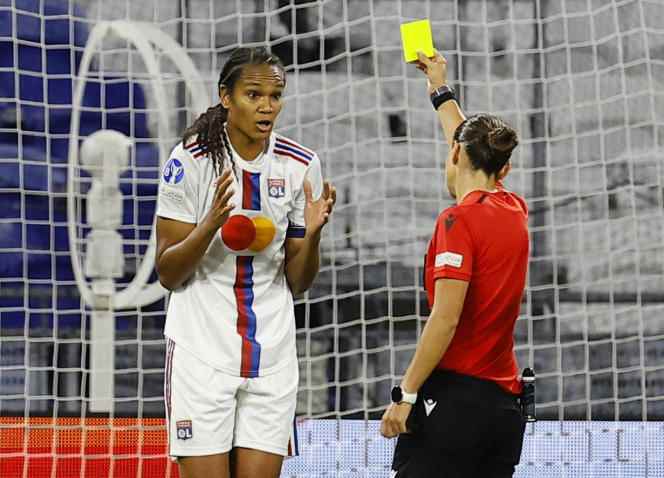 Lyonnaise Wendie Renard receives a yellow card during the Women's Champions League match against Arsenal, in Lyon, on October 19, 2022.