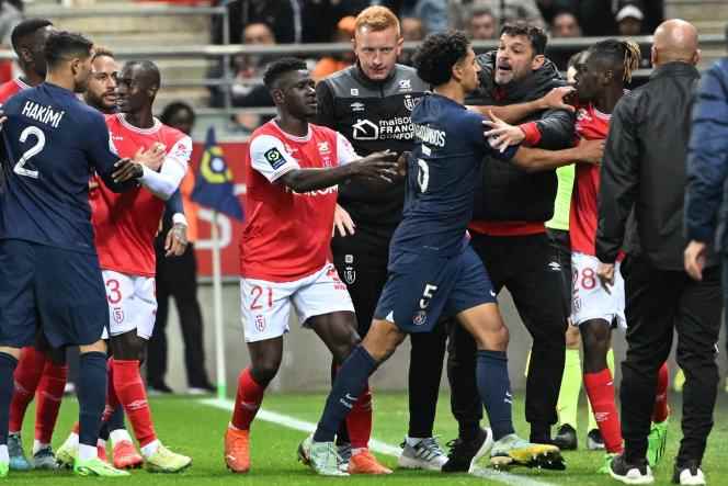 PSG's Brazilian defender Marquinhos and Stade de Reims defender Bradley Locko Banzouzi clash during the Ligue 1 match at Stade Auguste-Delaune in Reims on October 8, 2022.