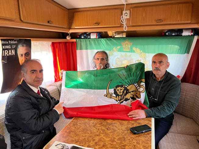 Nik Jafarzadeh, Saeed Ayhajan and Alihossan Mohamedikartalei (from left) show the former Iranian flag that unknown persons tried to steal.