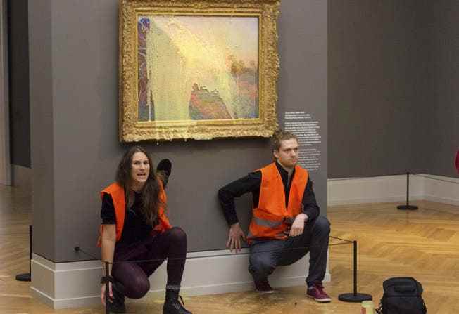 After their mashed potatoes toss, the radical members of the Last Generation group glued themselves under the Monet painting.