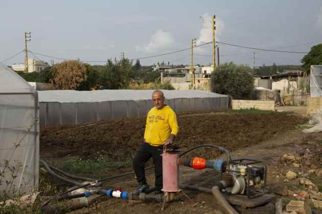 Farmer Ahmad Ajaj near the water filter he installed for watering his vegetables in Haryk, near the town of Bebnine, in northern Lebanon, Tuesday, November 1, 2022.