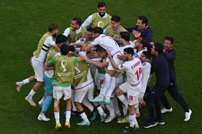 Iran players celebrate the opener in the match against Wales on November 25. 