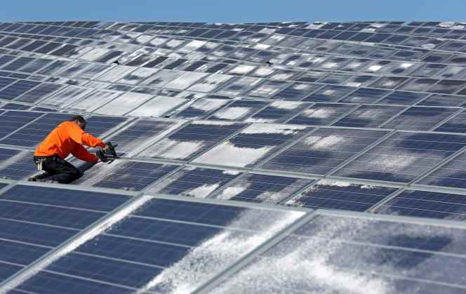 A maintenance worker works on solar panels at the solar energy company Norsol in Villaldemiro, northern Spain, February 10, 2015. 