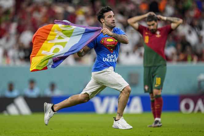 A fan steps onto the pitch during the match between Portugal and Uruguay and waves the LGBT rainbow flag, at Lusail Stadium, Qatar, Monday, November 28, 2022.