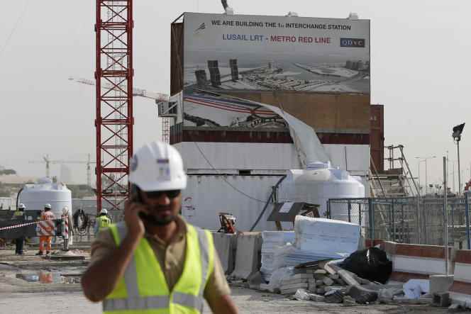 A worker from the QDVC (Qatari Diar/VINCI Construction Grands Projets) company walks through a construction site in Doha, Qatar, March 24, 2015.