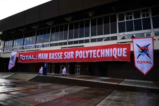 Activists from the environmental group Greenpeace demonstrate in front of the Ecole polytechnique against the link between the oil company Total and l'X, in Palaiseau, March 12, 2020.
