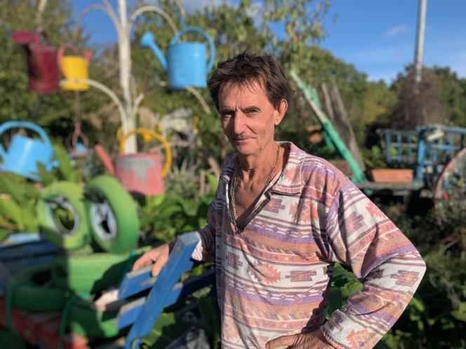 Jean-Claude Desneux, in front of his main “creation”: a watering can tree.