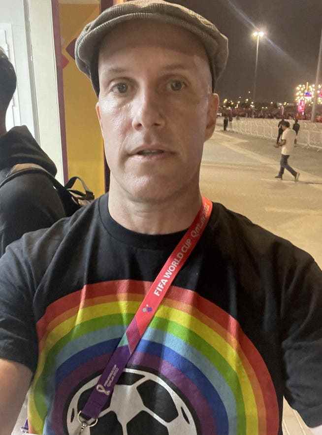 Grant Wahl said he was detained by security forces because of his rainbow logo T-shirt. 