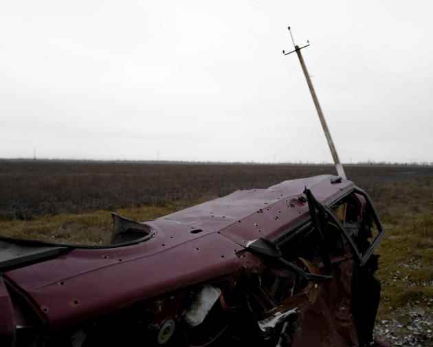 The car in which Gennady Vengrenovski and Anna Manzirokha were killed in March lies on the side of the road near Nadiezdhivka, Kherson Oblast, Ukraine, December 6, 2022. 