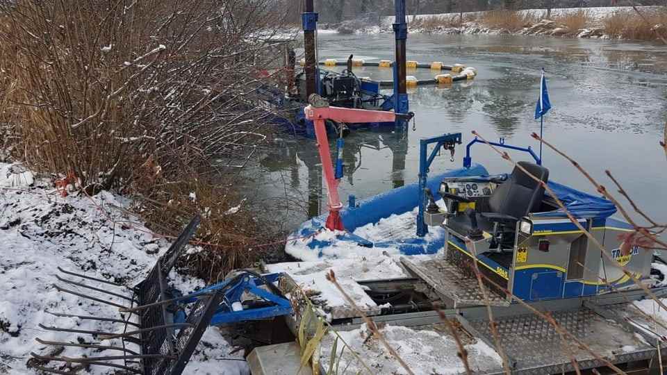 Dredger boat with snow and river