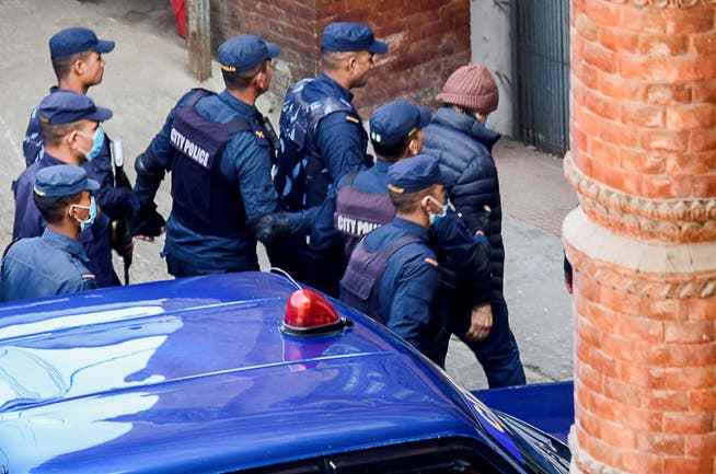 Charles Sobhraj is taken to the Immigration Department by police officers in Nepal on Friday. 