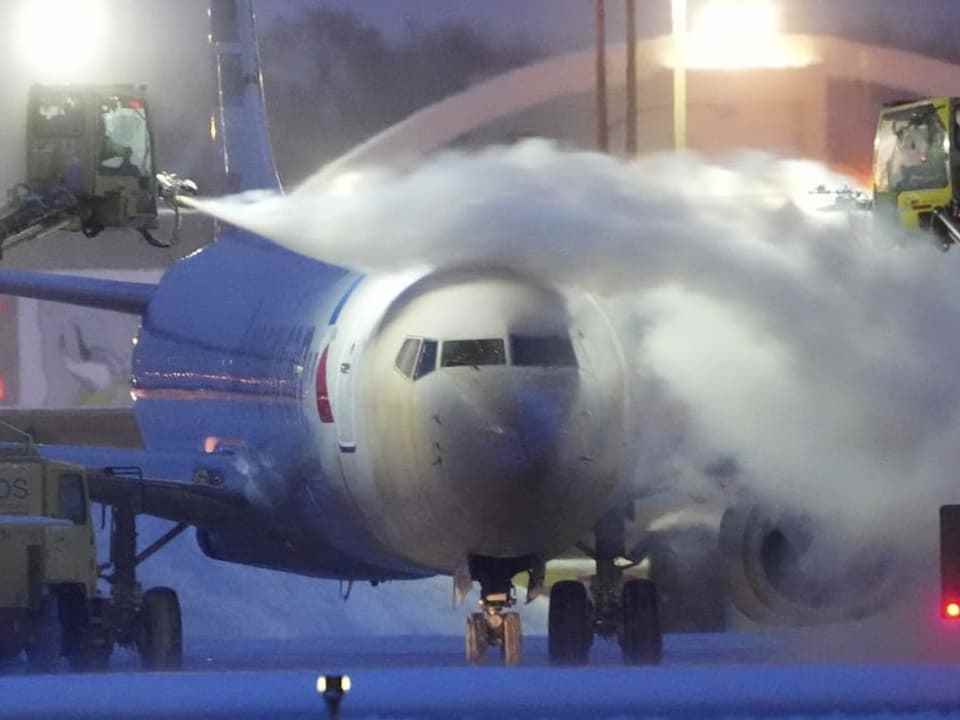 An airplane is de-iced.