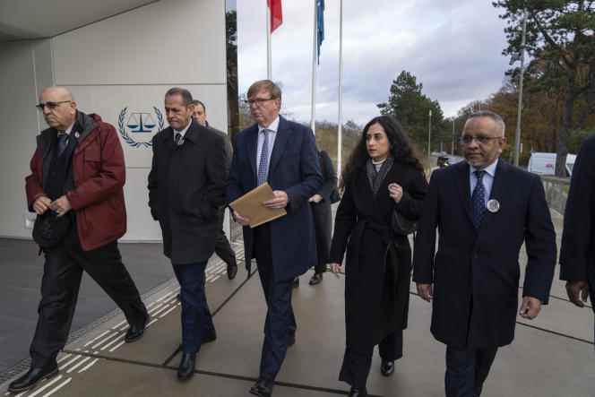 Attorney Rodney Dixon, lawyer for the Qatari Al-Jazeera channel, center, and Lina Abu Akleh, niece of Shireen Abu Akleh, on his left, surrender to the International Criminal Court in The Hague, Netherlands, on December 6 2022.