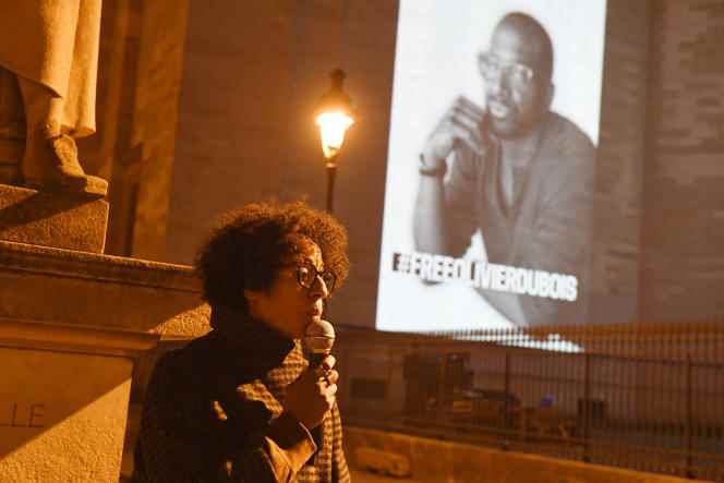 In front of the Panthéon, in Paris, on which an image of Olivier Dubois is projected, Canèle Bernard, half-sister of the journalist, speaks during a mobilization organized by Reporters without borders, March 7, 2022.