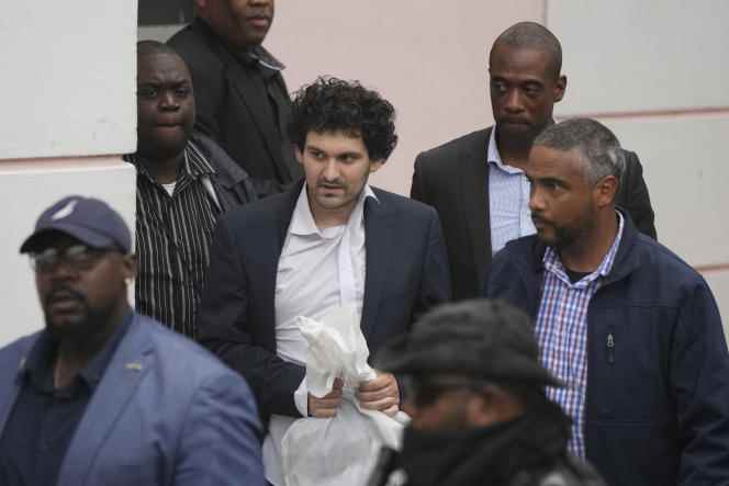 FTX founder Sam Bankman-Fried is escorted out of court in Nassau, Bahamas, after agreeing to be extradited, Dec. 21, 2022.