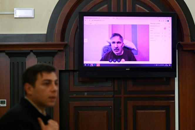 Mikheil Saakashvili, former president of Georgia, appears on a video screen via video link from his hospital bed, during a deliberation hearing to decide whether he should be released or postpone his sentence for health reasons , in Tbilisi, on December 22, 2022. 