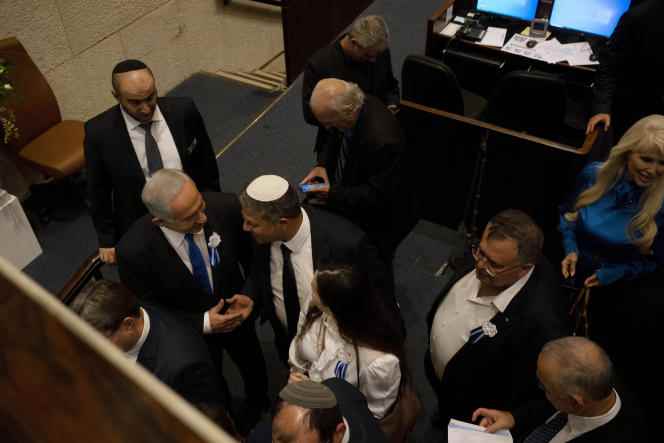 Benyamin Netanyahu, the future Israeli prime minister (left), and Itamar Ben Gvir, leader of the Religious Zionism list, shake hands, at the Knesset, in Jerusalem, November 15. 