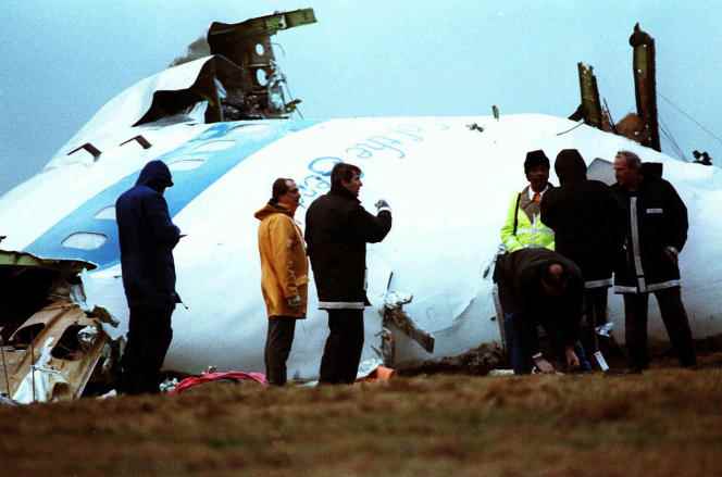 Investigators in front of the wreckage of the Pan Am Boeing 747 in Lockerbie, Scotland, December 23, 1988.