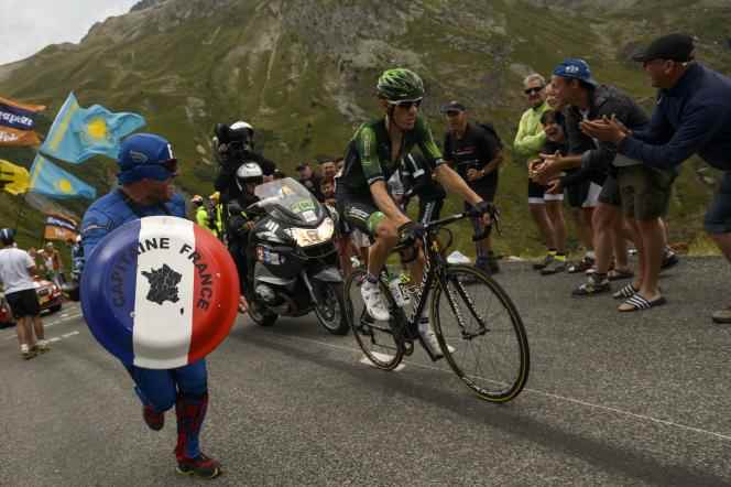 Pierre Rolland under the encouragement of a disguised supporter during the 19th stage of the 102nd edition of the Tour de France, July 24, 2015, between Saint-Jean-de-Maurienne and La Toussuire, in the Alps. 