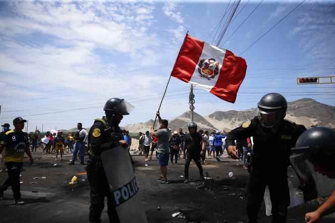 Supporters of deposed Peruvian President Pedro Castillo demonstrate on a highway as police arrive to clear debris, in Chao, northern Peru, December 15, 2022.