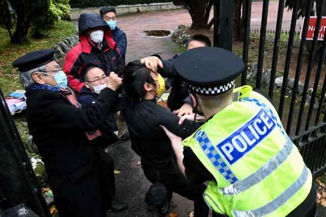 A British policeman tries to intervene as clashes erupt between pro-democracy protesters in Hong Kong and members of the Chinese consulate in Manchester, during a protest on October 16, 2022.