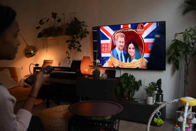 A Londoner watches the 'Harry and Meghan' docuseries on December 8, 2022.