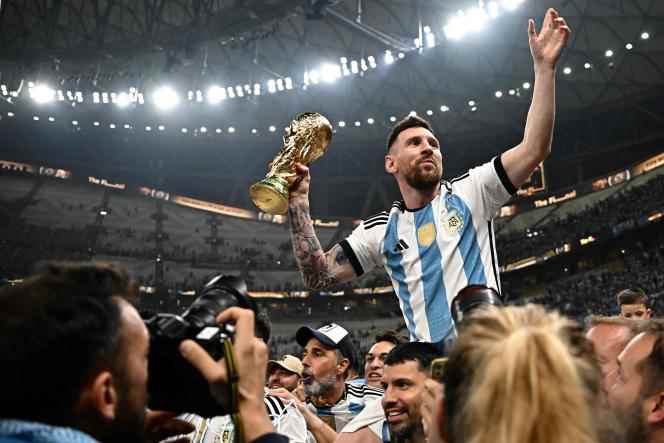 Victorious over France, Argentina captain Lionel Messi holds the World Cup trophy, Sunday, Dec. 18, 2022, in Doha, Qatar.  