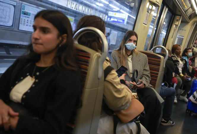 A woman wears a mask in the metro in Paris, June 30, 2022.