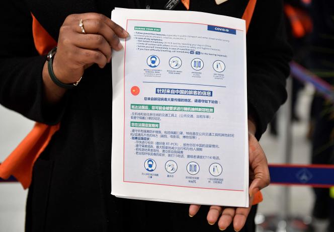 This photo shows an information document on Covid-19 preventive measures given to passengers on a flight from China at Paris-Charles-de-Gaulle airport in Roissy, in the suburbs of Paris, on January 1, 2023, while that France reinforce health measures at the borders for travelers arriving from China.