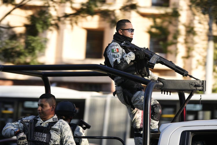 Guardia Nacional officers secure buildings in Culiacan following Ovidio Guzmán's arrest. 