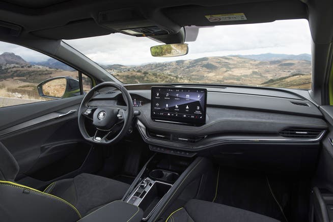A generous center display contrasts with a small cluster of instruments in front of the steering wheel.