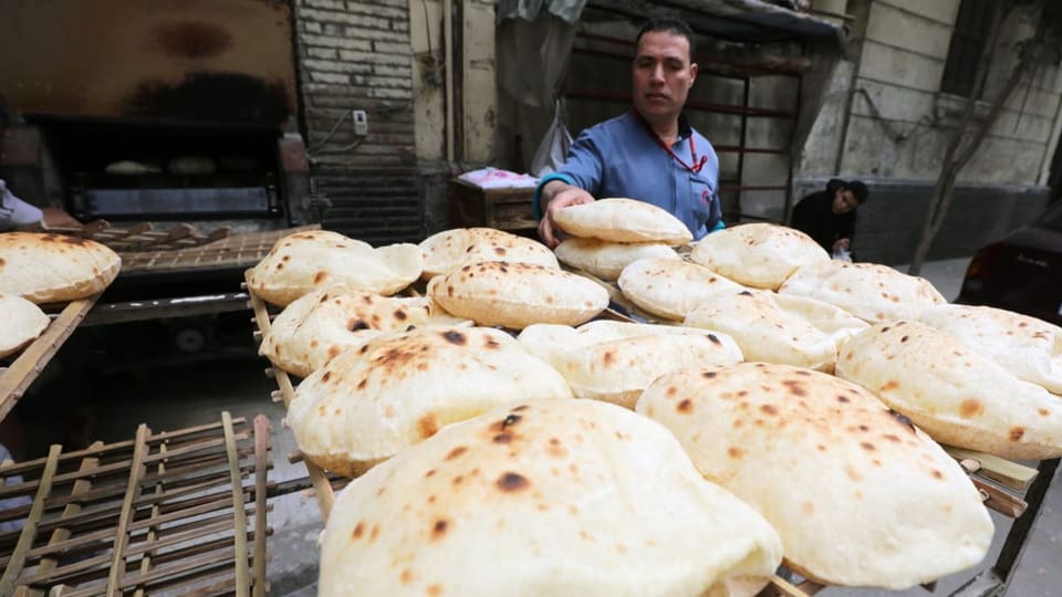 Loaves of bread and a seller in Cairo.