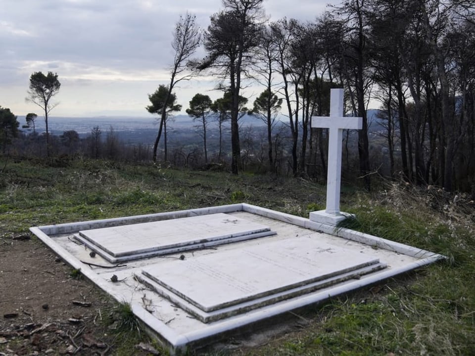 Tomb on a hill with a cross.