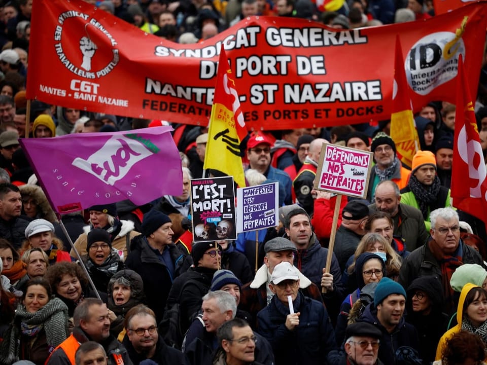 Demonstrators protest with French union flags