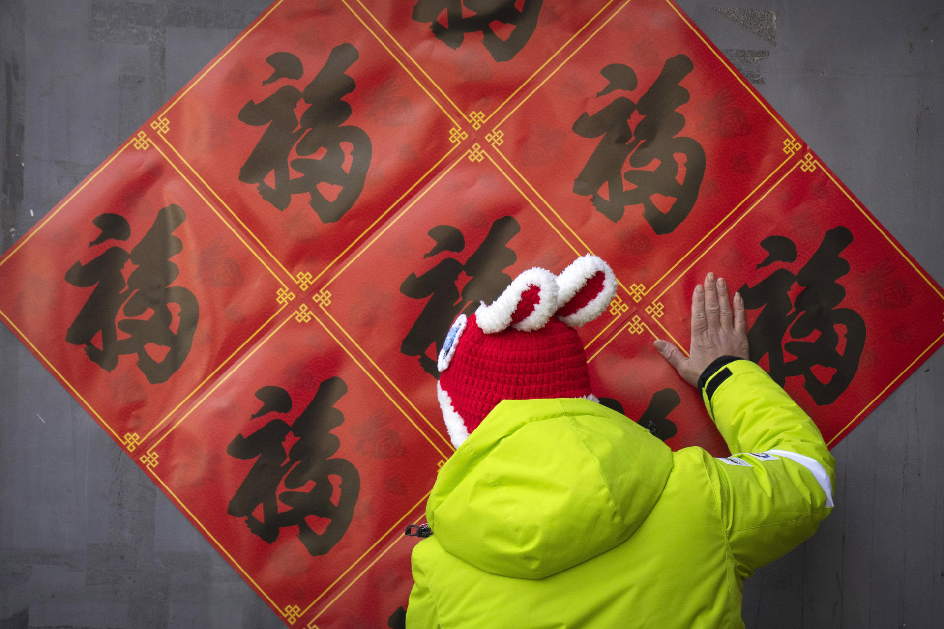 A woman in front of a wall decoration, in Beijing, on January 21, 2023.