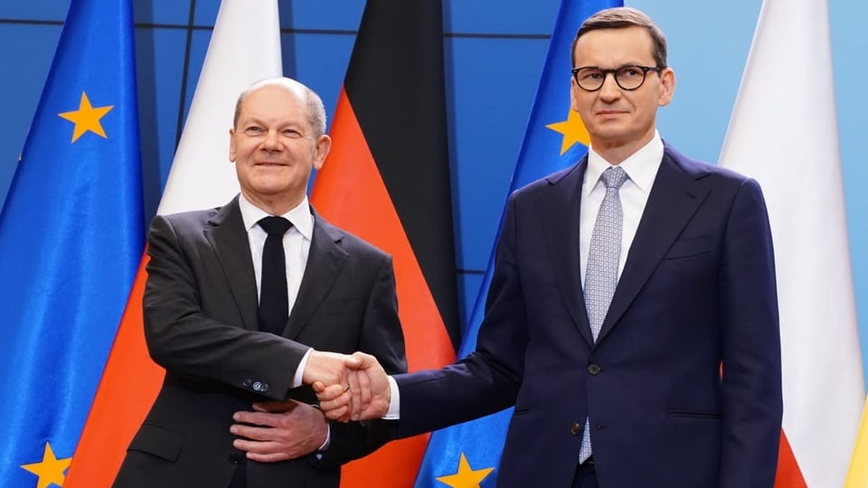 Chancellor Olaf Scholz (left) shaking hands with Poland's Prime Minister Mateusz Morawiecki