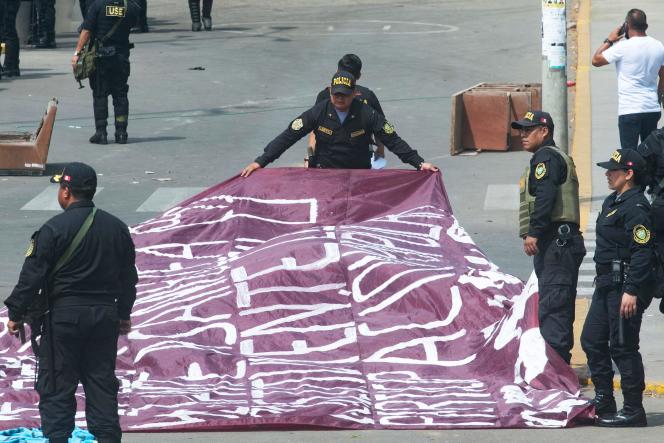 Police officers seize posters and banners from protesters, on the campus of the Major National University of San Marcos, in Lima (Peru), on January 21, 2023.