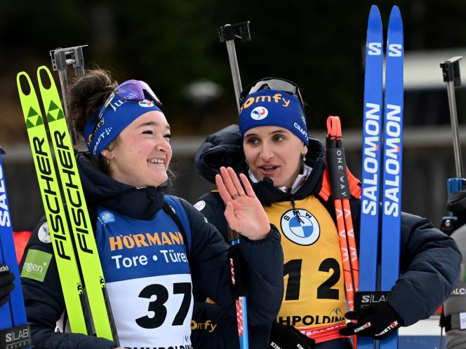 Julia Simon (right) and Lou Jeanmonnot wait to step onto the podium in the individual event in Ruhpolding, Germany, on January 12.  The French women finished third and second respectively in the event won by the Italian Lisa Vittozzi.
