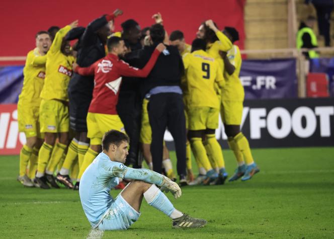 Monegasque goalkeeper Thomas Didillon disappointed as Rodez players celebrate their qualification against the club from the principality, at the Louis II stadium in Monaco, January 7, 2023.