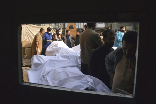People identify the bodies of their relatives, killed in the suicide bombing inside a mosque, at a hospital in Peshawar, Pakistan, January 30, 2023.