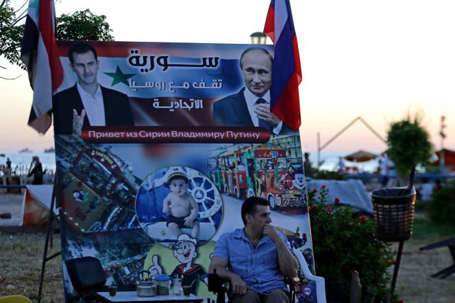 A poster depicting Syrian President Bashar Al-Assad and his Russian counterpart Vladimir Putin in Tartous, Syria, July 24, 2022. It reads: “Syria stands with the Russian Federation”.