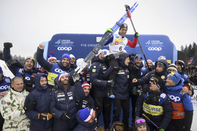 Richard Jouve celebrates his victory with the members of the French cross-country skiing team for the classic World Cup sprint event in Les Rousses (Jura), January 28, 2023. 