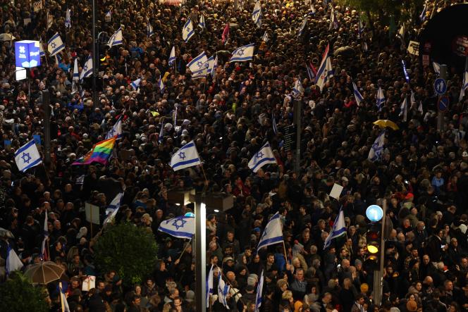 Israeli protesters during a rally against Binyamin Netanyahu's new government in Tel Aviv on January 14, 2023. 