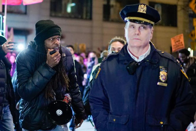 A protester shouts slogans near a police officer during a rally in New York City on January 28, 2023, the day after videos of the fatal police arrest of Tire Nichols were released to the public.