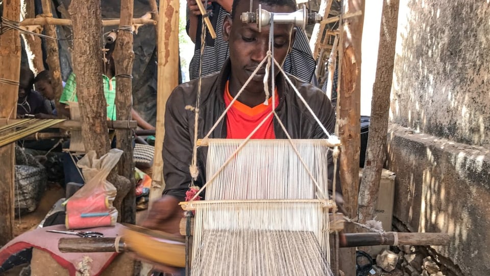 Young man at a loom.