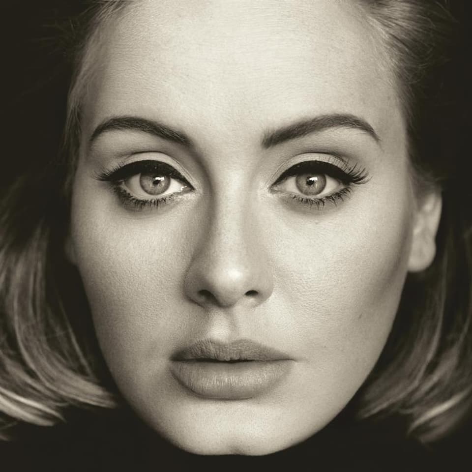 Close-up of Adele in black and white.  She has a sensual look and is heavily made up.