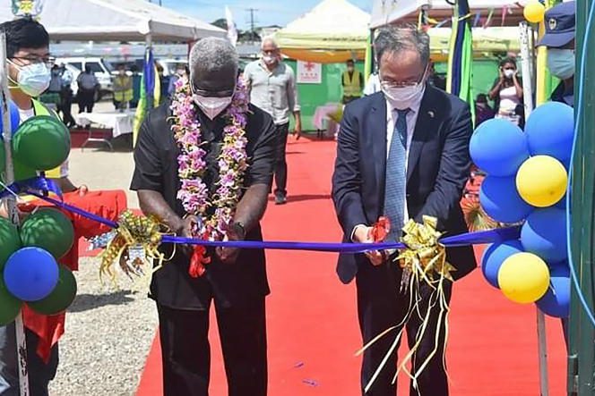Chinese Ambassador to the Solomon Islands Li Ming (right) and Solomon Islands Prime Minister Manasseh Sogavare (left) cutting a ribbon during the opening ceremony of a national stadium complex funded by the China in Honiara on April 22, 2022.
