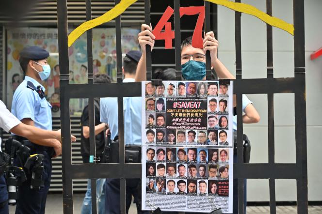 On September 19, 2021, a demonstrator holds up the portrait of the forty-seven pro-democracy activists imprisoned thanks to the national security law.  Their trial was scheduled to start on February 6, 2023.