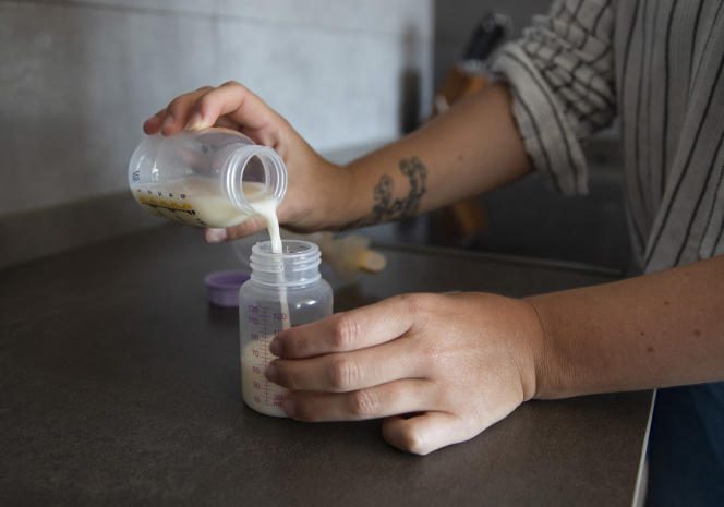 A woman bottles her breast milk to donate to the breast milk bank in Palma de Mallorca, Spain, May 13, 2021.