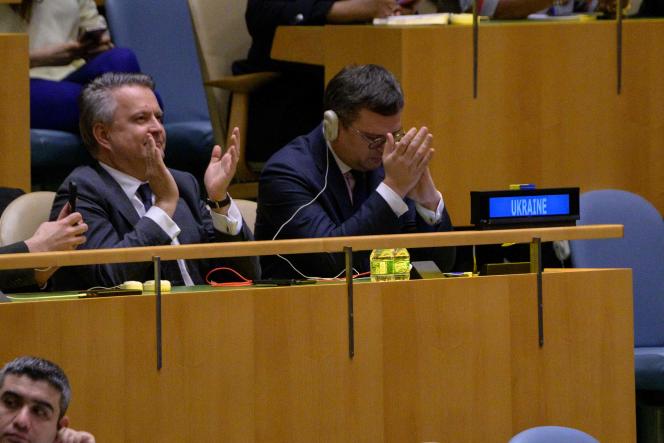 Ukrainian Foreign Minister Dmytro Kuleba (R) and Ukrainian Ambassador to the United Nations Sergiy Kyslytsya applaud after the vote on the resolution calling for the withdrawal of Russian troops from Ukraine, February 23, 2023, in New York.